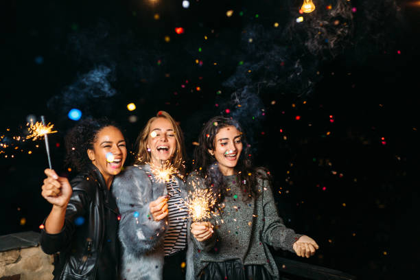 istock Three happy women having fun with sparklers. 856386026