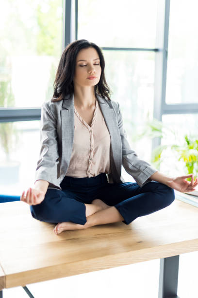 istock businesswoman meditating at workplace 856391956