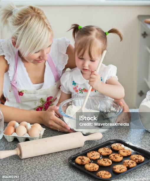 Mother and Daughter Putting Dough in Form for Baking Cookies Stock Image - Image
