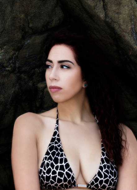 istock Attractive Hispanic Woman Bikini Top Against Rocks 856392518