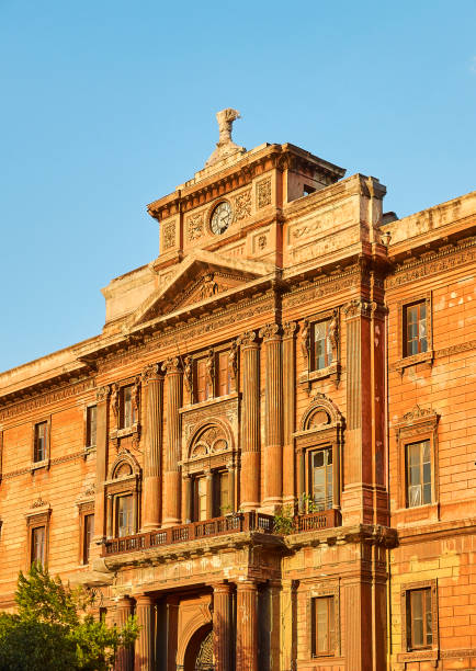 Palazzo degli Uffizi palace of Taranto, Apulia, Italy. Taranto, Italy - August 11, 2017. Palazzo degli Uffizi palace in Piazza Garibaldi gardens at sunset. Taranto, Apulia, Italy. taranto stock pictures, royalty-free photos & images