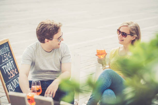 istock Couple drinking cocktail outdoors 856395012