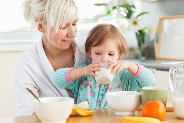 istock Radiant woman having breakfast with her daughter 856395138