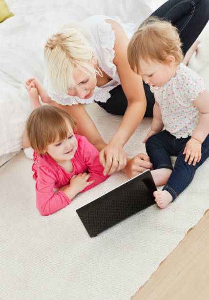 istock Cute family having fun with a laptop 856395154