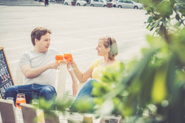 istock Couple drinking cocktail outdoors 856395372