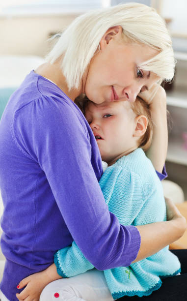 istock Blond woman taking care of her child 856395440