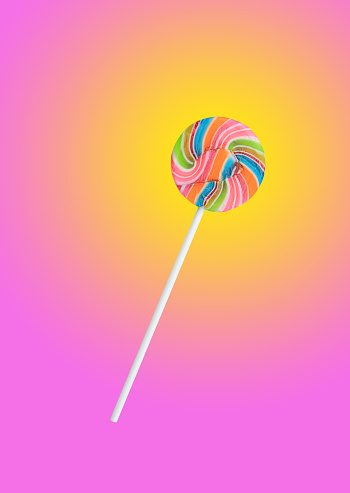 Rainbow color lollipops on pink background.