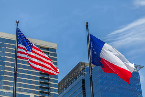 istock American and Texas Flag on Top of the Pole 856400992