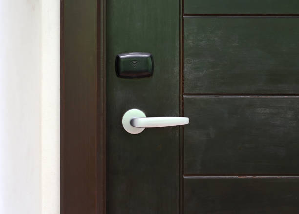 istock Door handle with access key on wooden door. 856403692