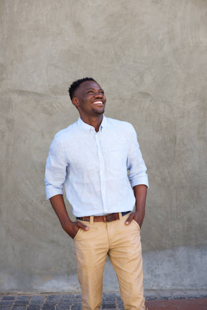 istock modern young black man smiling with hands in pockets 856403800