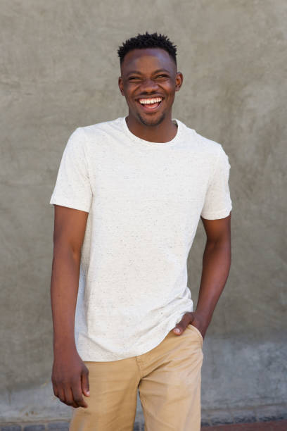 istock smiling young african american guy walking outside 856404092