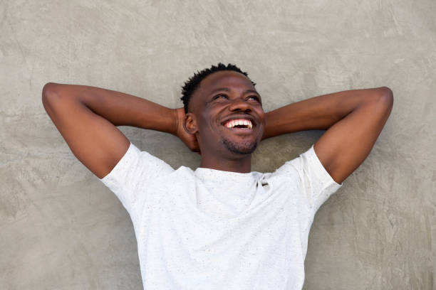 istock young african american man smiling with hands behind head 856404110