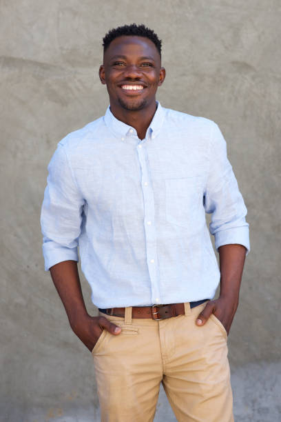 istock handsome african american man smiling by wall 856404274