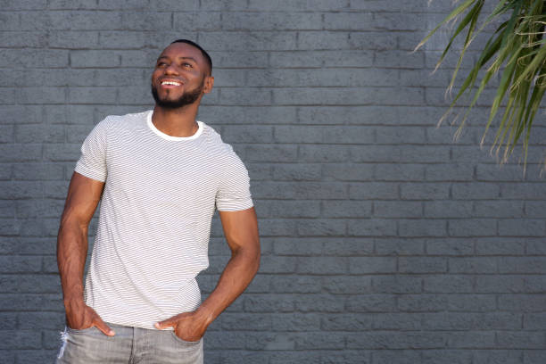 istock Portrait of smiling handsome man standing by wall outside 856407058