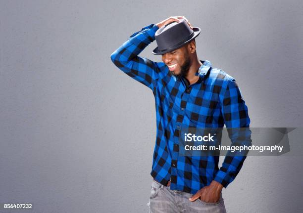 Happy Handsome Man Laughing With Hand To Hat Stock Photo - Download Image Now - African-American Ethnicity, Beard, Fashion Model