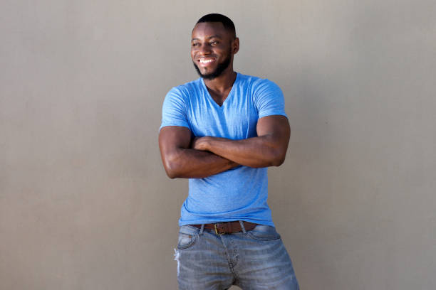 istock handsome man with beard smiling with arms crossed 856407466