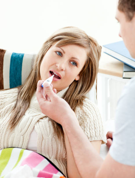 istock Handsome boyfriend taking temperature of his girlfriend 856409892