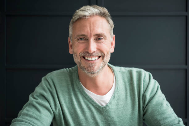 istock Cheerful man in his 40s wearing green sweater facing camera and smiling 856410964