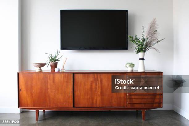 Wall Mounted Tv In Mid Century Modern Furnished Apartment Stock Photo - Download Image Now
