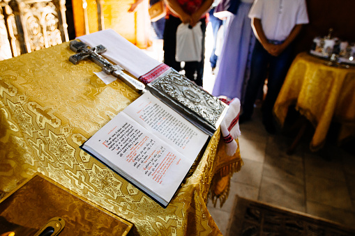 Dnipro, Ukraine - August 06, 2017: bible on reading-desk or lectern, sacred lectern in the church decorated with golden friezes and ornaments