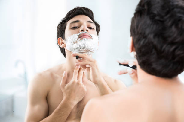 Man shaving in the bathroom. Man shaving in the bathroom. shaving stock pictures, royalty-free photos & images