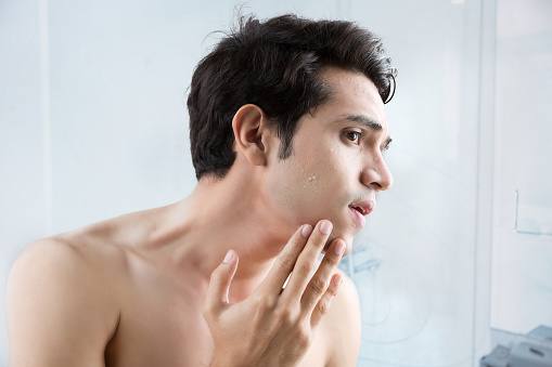 Man shaving in the bathroom.