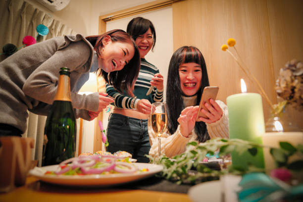 istock Women enjoying a Christmas party at a friend's house 856420954