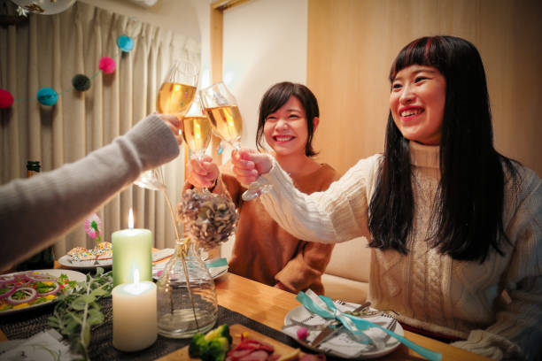 istock Women enjoying a Christmas party at a friend's house 856420982