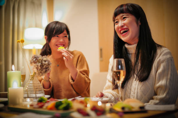 istock Women enjoying a Christmas party at a friend's house 856420984
