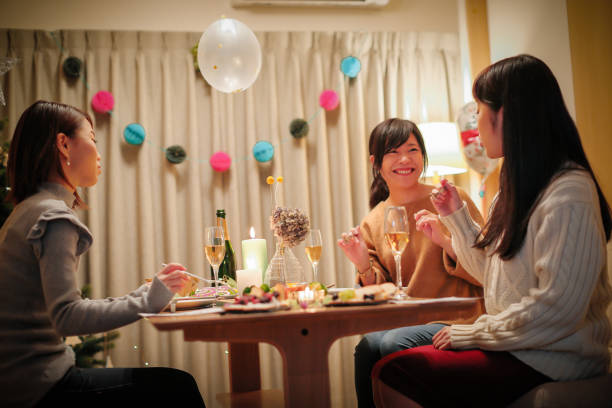 istock Women enjoying a Christmas party at a friend's house 856420990