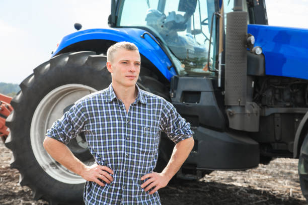 istock Young attractive man near a tractor. Concept of agriculture. 856424244