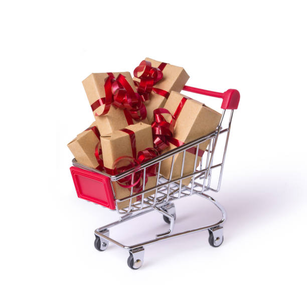Creative concept with shopping trolley with gifts isolated on a white background.