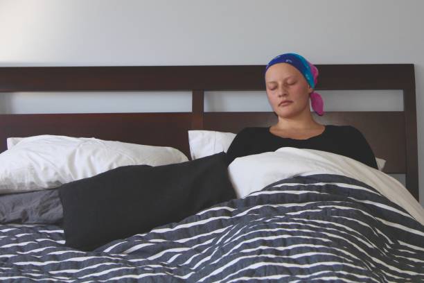 Cancer patient sleeps in bed stock photo