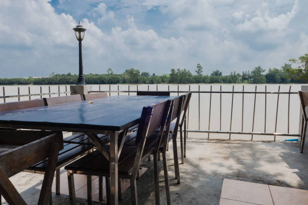 istock Wooden table and chair outdoor at Riverside 856434642