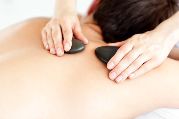 istock Close up of a man with hot stone on his back 856441298