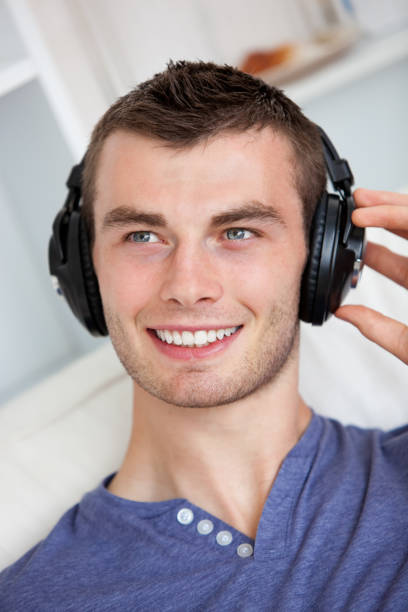 istock Handsome young man listening to music with headphones 856449300