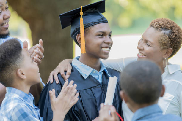 istock Cheerful high school graduate with his family 856451814