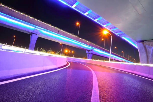 istock Empty road floor with city overpass viaduct bridge of neon lights night scene 856457836