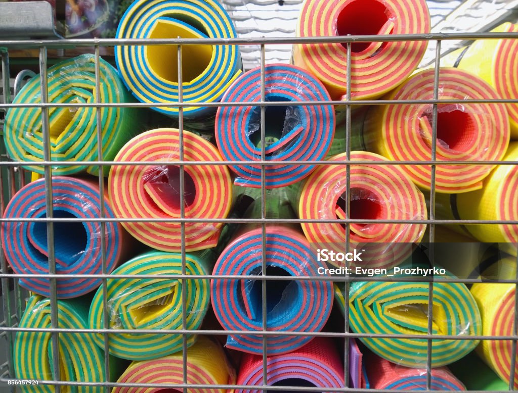 Multicolored Yoga mats in store. Choice Stock Photo