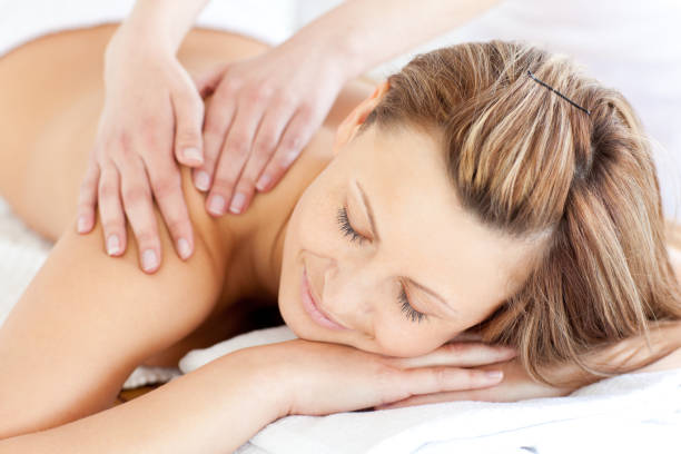 istock Delighted young woman having a back massage 856461532
