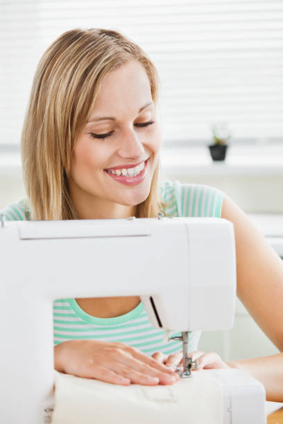 istock Portrait of a smiling woman sewing clothes at home 856466010