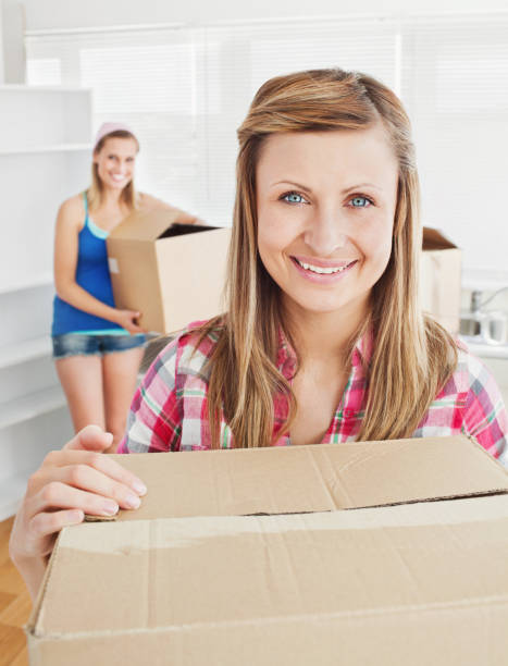 istock Delighted woman holding boxes after moving 856466074