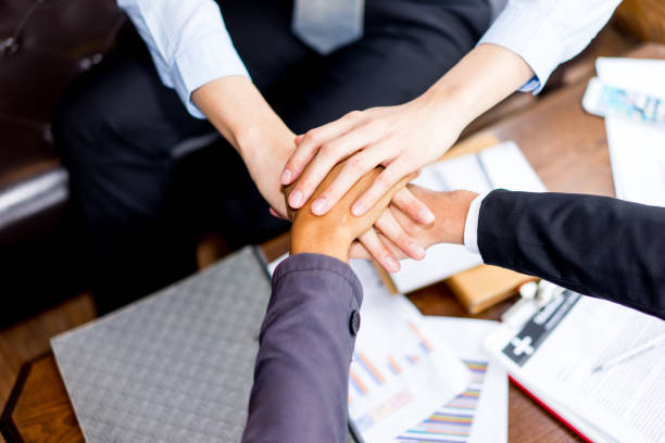 istock Close up top view of business people putting their hands together 856468486