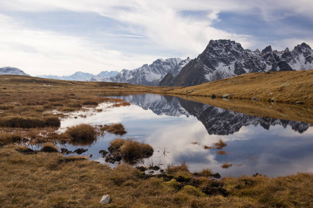 istock Scenics lake landscape with larches forest on mountain in sunny autumn fall day outdoor 856476348