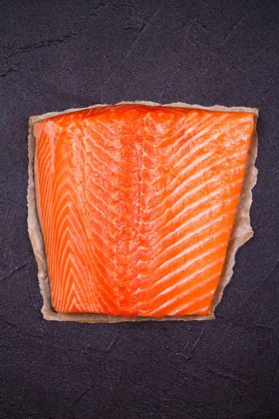istock Raw salmon fish fillet on black background. View from above, top studio shot 856481402