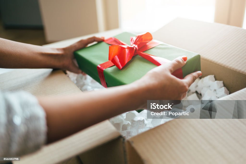 Close up of hands holding gift box Close up of woman hands opening parcel with present box. Christmas Stock Photo