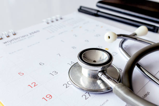 annual checkup concept. stethoscope on the calendar with soft-focus and over light in the background annual checkup concept. stethoscope on the calendar with soft-focus and over light in the background annual event stock pictures, royalty-free photos & images