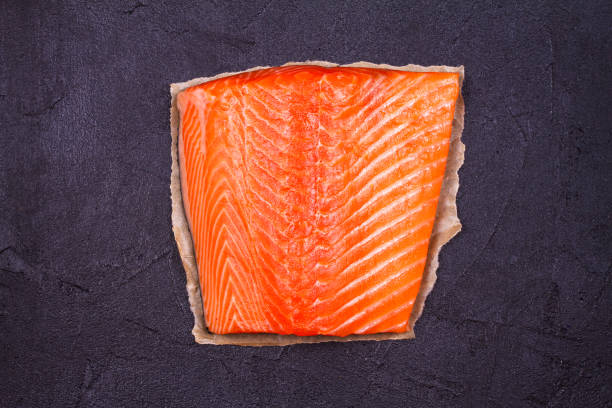 istock Raw salmon fish fillet on black background. View from above, top studio shot 856484266