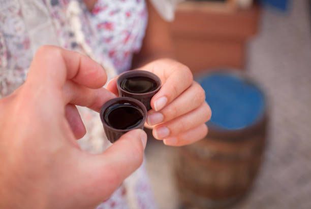 Ginja de Obidos, traditional cherry liquor of Portugal,  in the hands of tourists, close-up Ginja de Obidos, traditional cherry liquor of Portugal,  in the hands of tourists, close-up obidos photos stock pictures, royalty-free photos & images