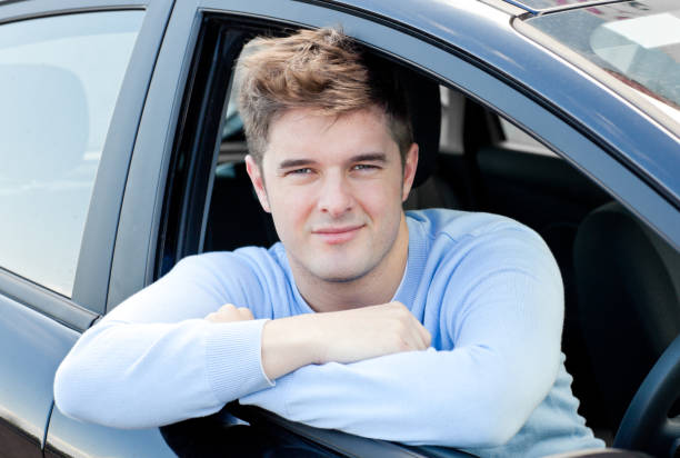istock Positive young man sitting in his car 856486022